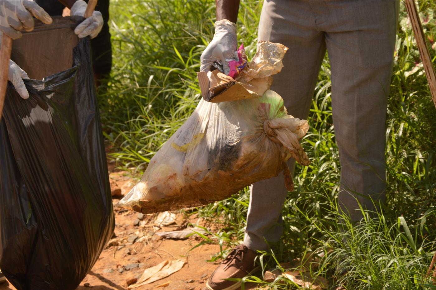 Participants carrying waste bags during the clean-up activity in Paynesville City.