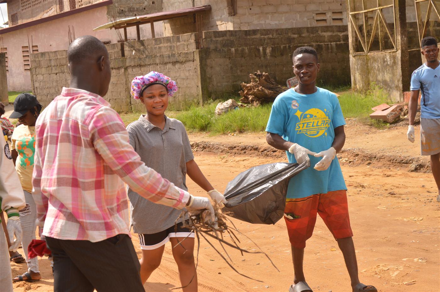 Young volunteers carrying waste bags during the World Environment Day clean-up.
