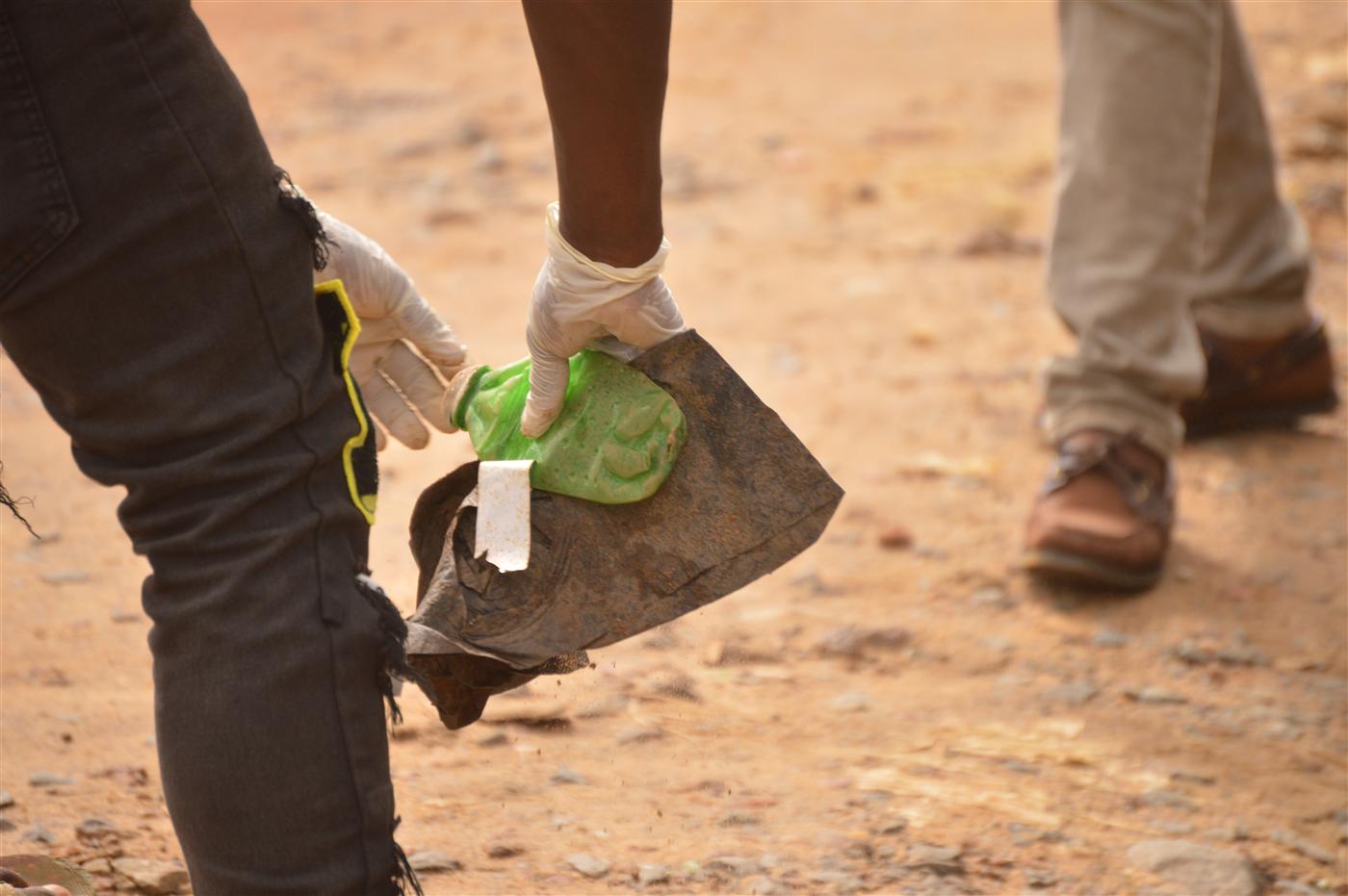 Volunteers removing plastic waste and debris from the community.