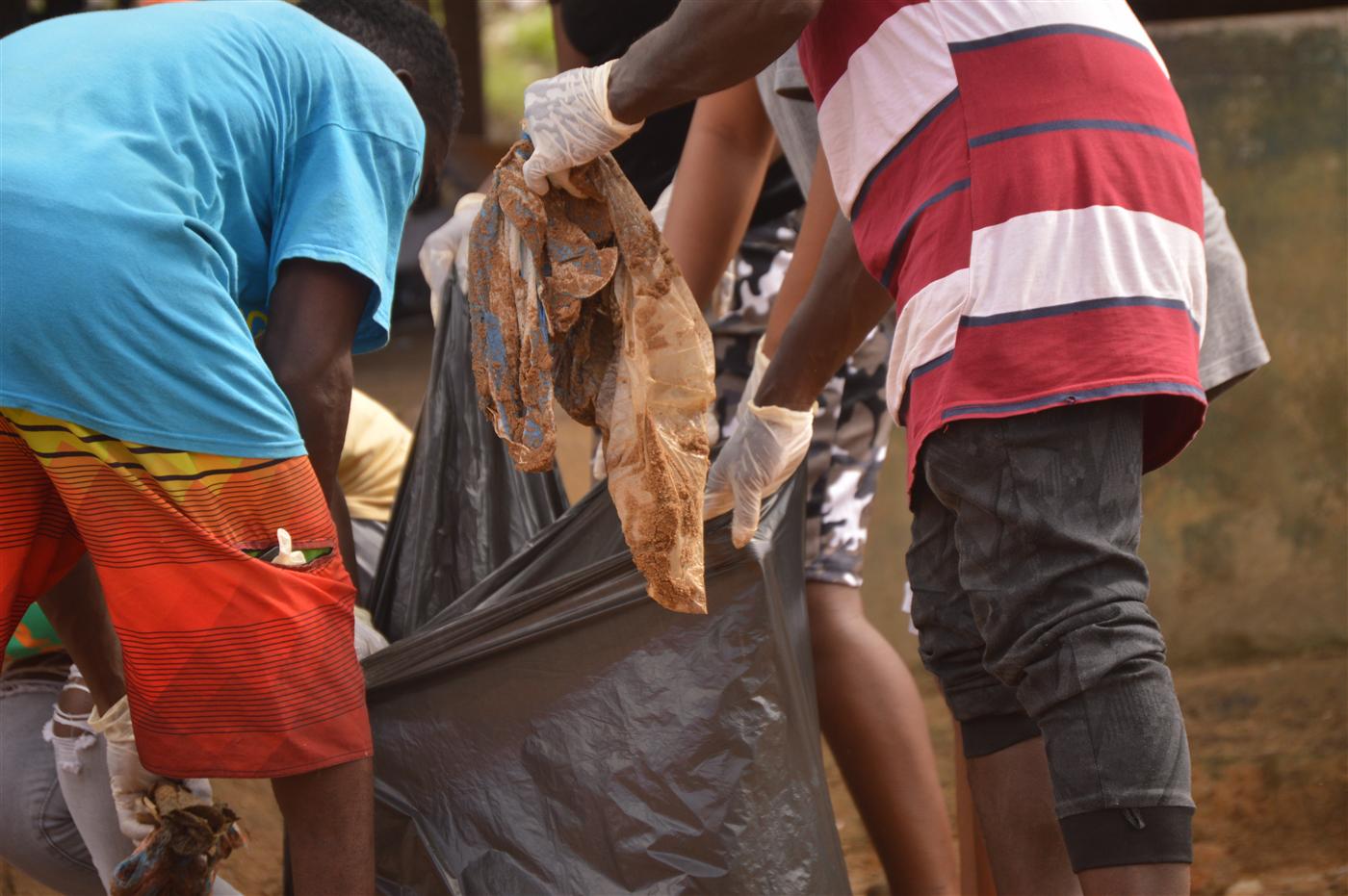 Collected waste being placed into bags during the community clean-up.