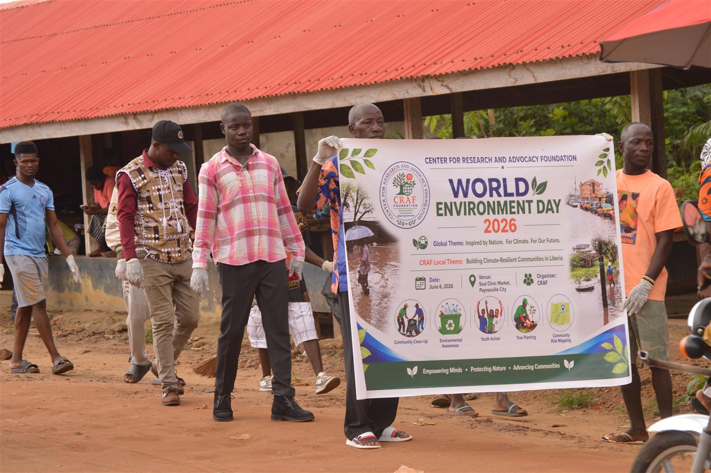 Participants holding the World Environment Day 2026 banner during the clean-up.