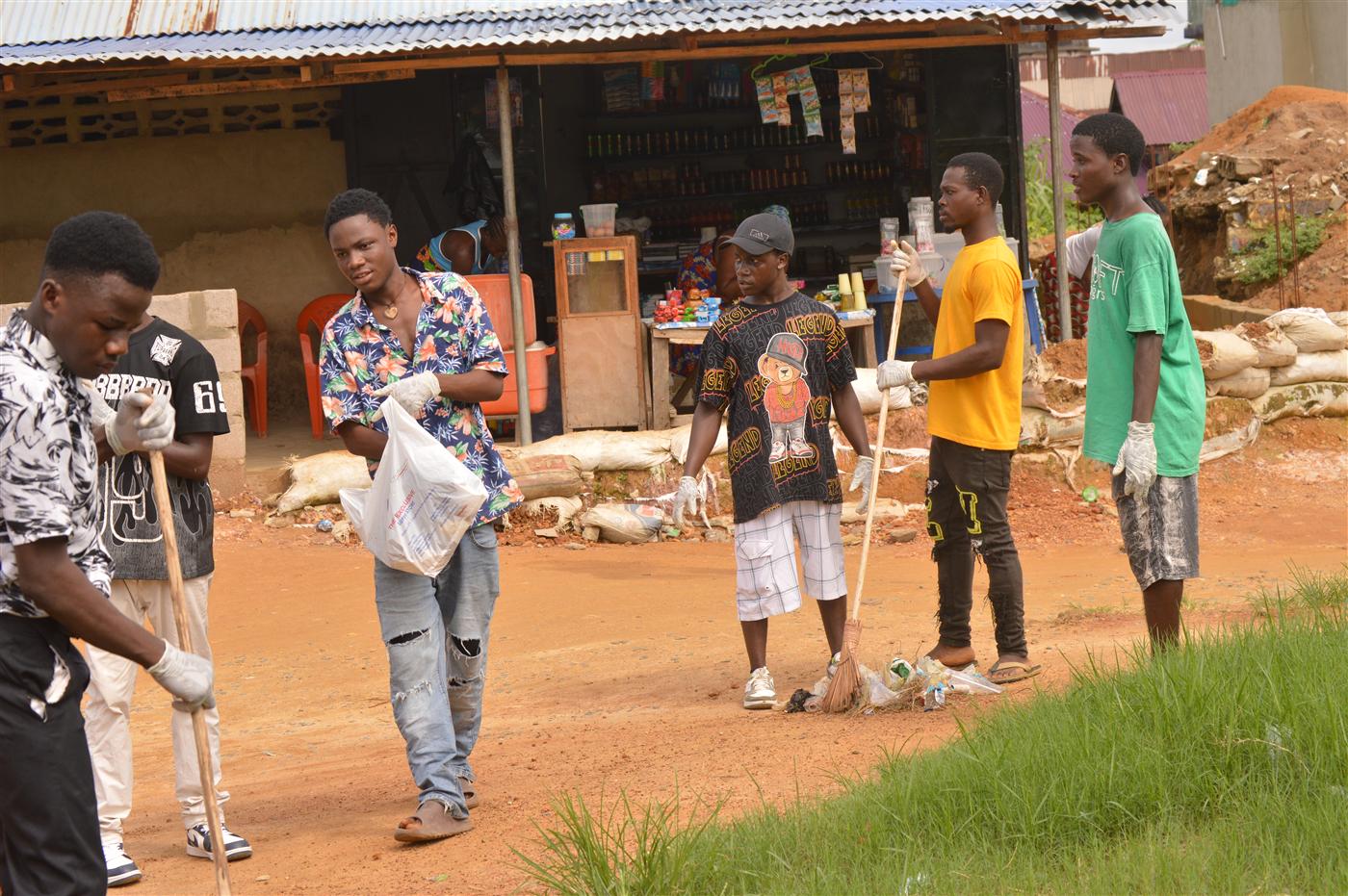 Youth volunteers and community members working together to clean public spaces.