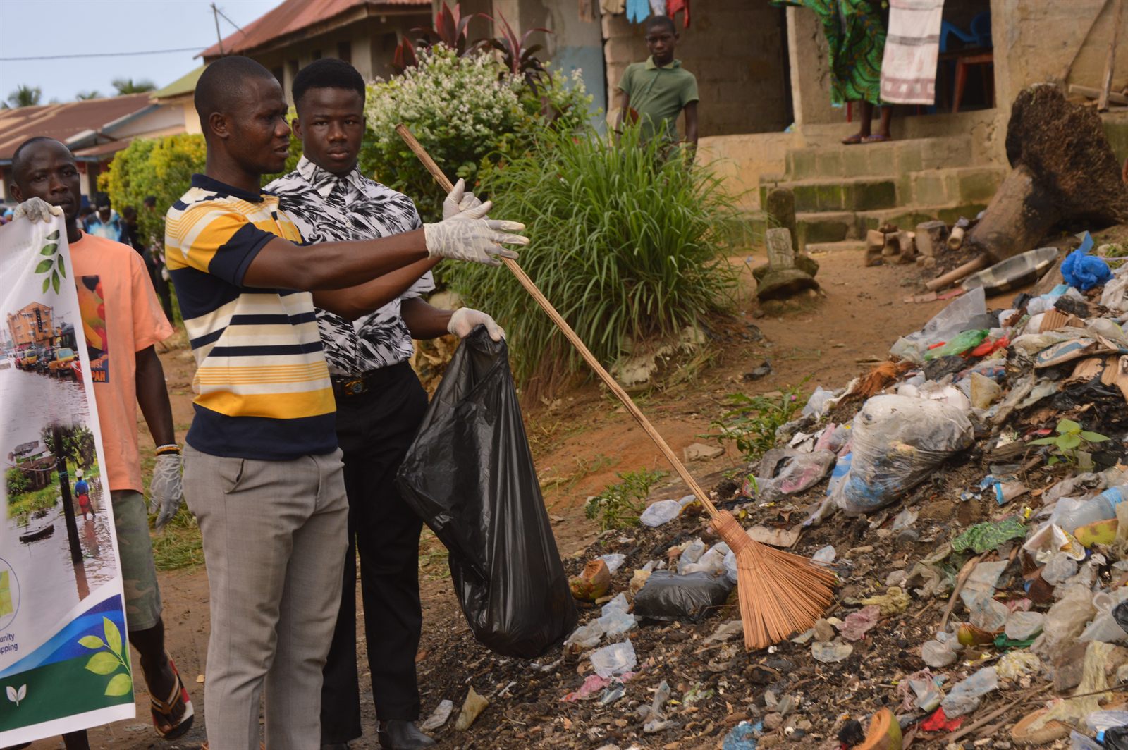 CRAF volunteers cleaning areas affected by poor waste disposal and blocked drainage.
